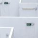 Multiple green exit signs on gray maze walls